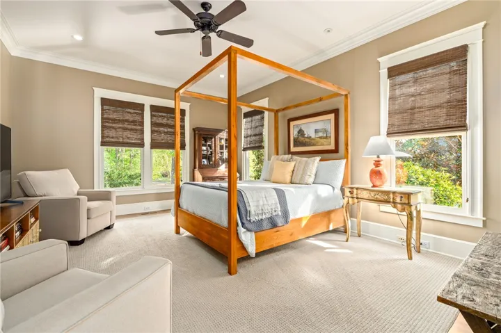 Spacious primary suite on main level. Look out the windows to beautiful landscaping - it's your own private oasis!