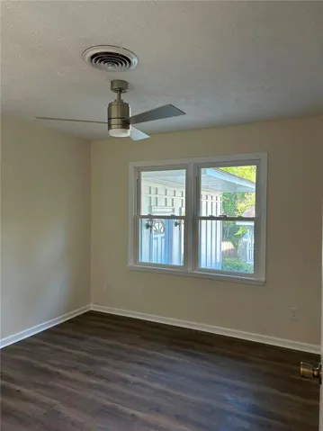 This bright room features durable flooring, offering a versatile space for various uses.