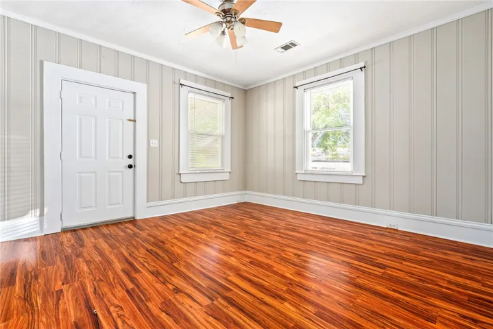 This bright room features durable wood flooring and ample natural light.