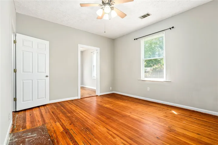 This bright room features beautiful hardwood floors and ample natural light.