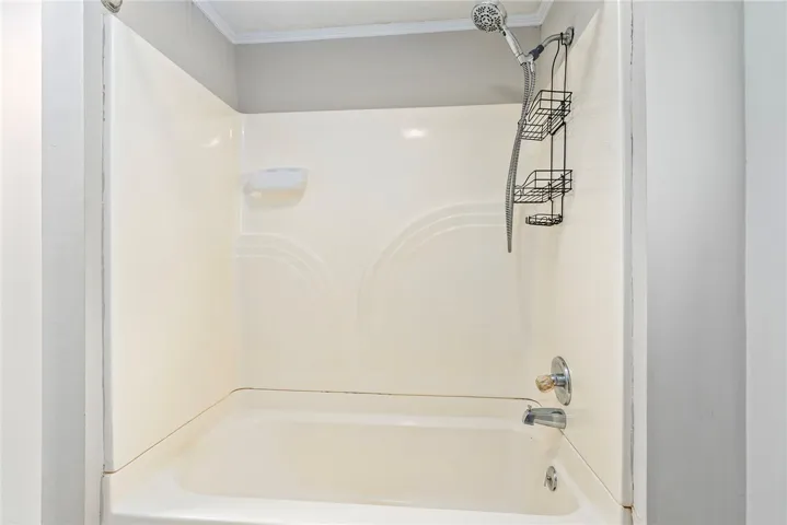 This bathtub and shower combination provides a clean and functional space for daily routines.