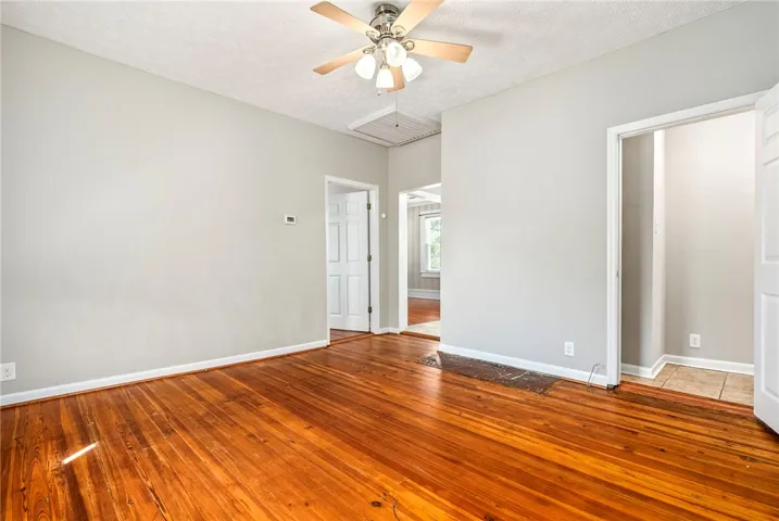 This living space features warm hardwood floors and abundant natural light, offering a welcoming atmosphere.