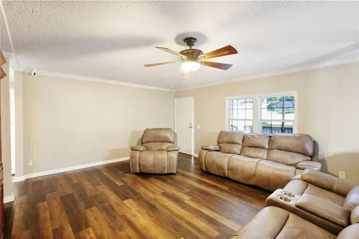 This inviting living space features warm flooring and ample natural light, perfect for everyday comfort.