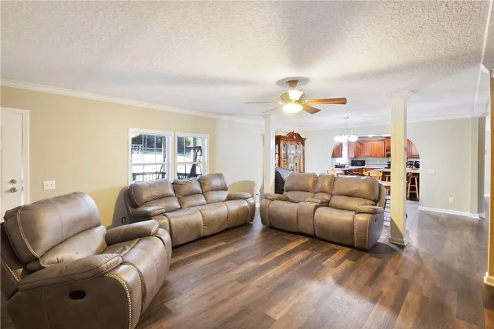 This living room features rich wood flooring, crown molding, and an inviting open floor plan.