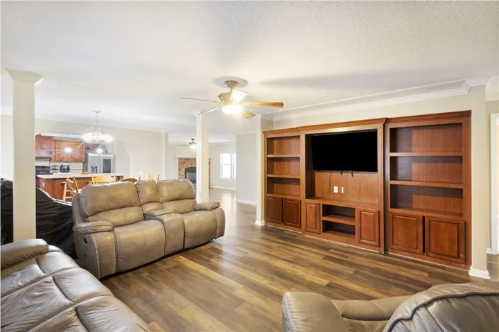 This inviting space features an open layout with rich wood flooring and elegant crown molding.