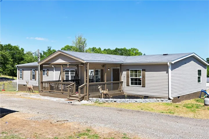This charming residence features a welcoming porch and a spacious, well-maintained exterior.
