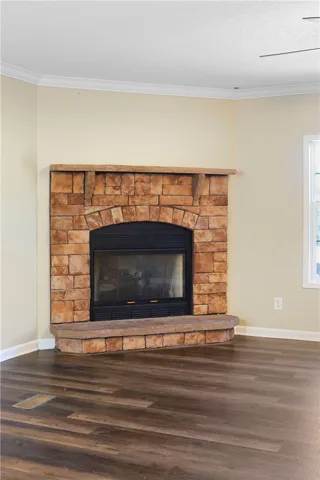 This inviting living space features a corner fireplace, offering warmth and a focal point.