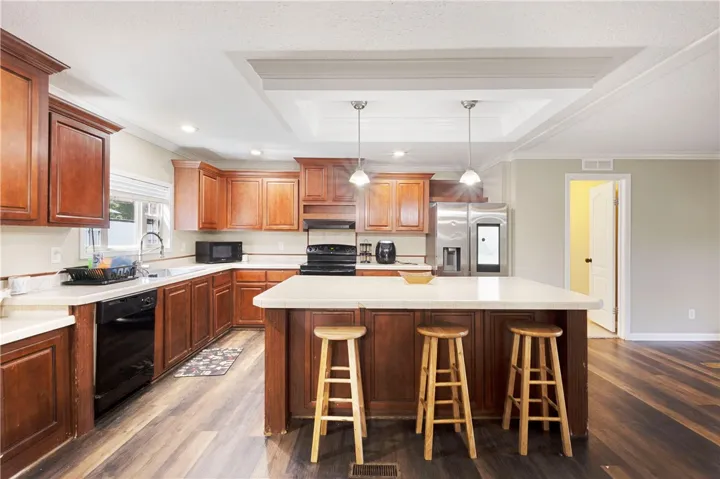 This spacious kitchen offers a large island, ample cabinetry, and modern appliances for daily living.