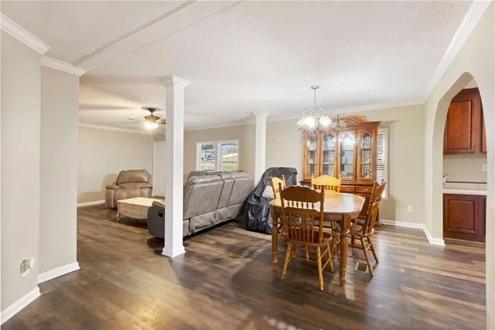 This inviting space features durable flooring and architectural details, connecting living and dining areas seamlessly.