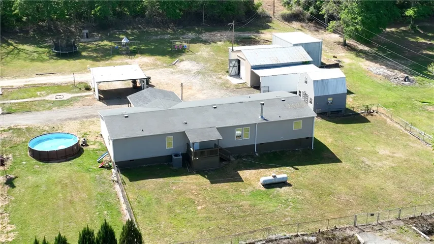 This spacious property offers a refreshing pool and ample outdoor space, perfect for leisure.