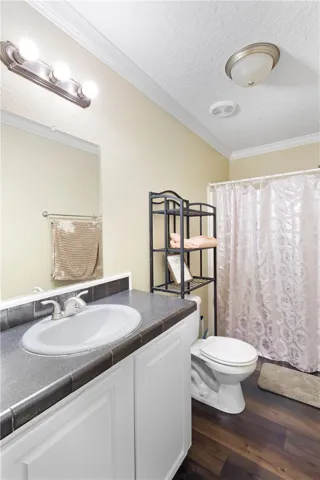 This bathroom features a contemporary vanity and dark flooring, offering a modern aesthetic.