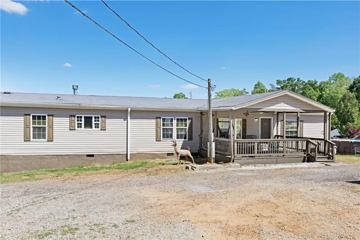 This inviting residence features a covered porch, offering a perfect blend of comfort and outdoor living.