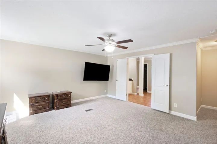 This spacious primary bedroom offers comfort and a seamless transition to the ensuite bathroom.