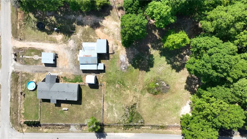 This expansive property features mature trees and ample space for various outdoor pursuits.