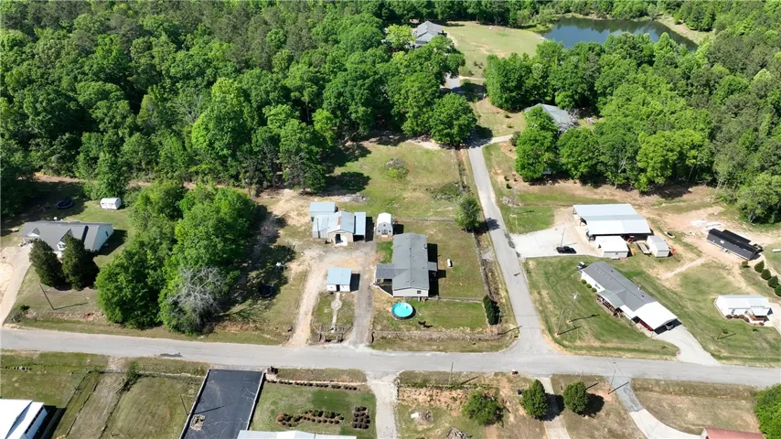 An aerial view showcases this expansive property, complete with a private pool and outbuildings.