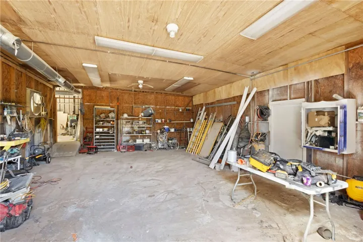 This spacious garage offers ample room for projects and storage, featuring durable concrete flooring.