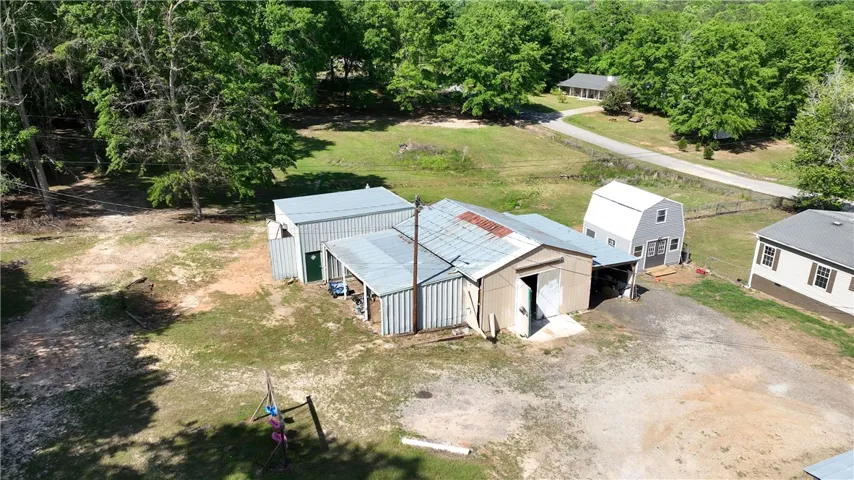 This expansive property offers multiple structures and abundant outdoor space for diverse uses.