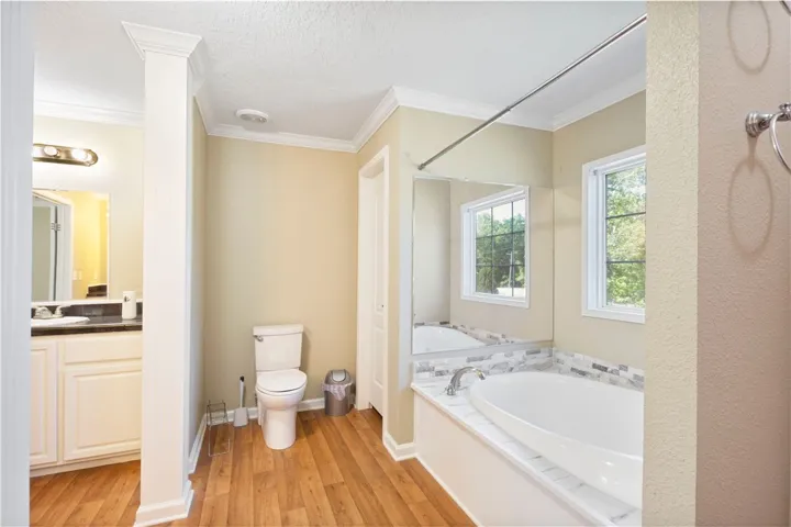 This serene bathroom offers a spacious soaking tub and ample natural light.