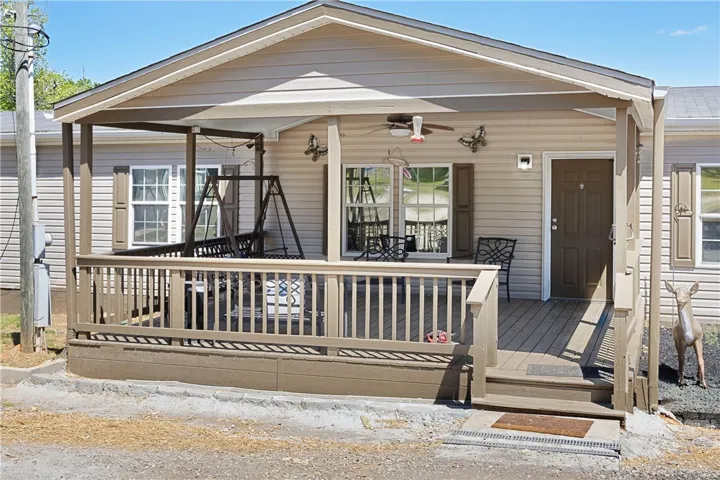 This inviting porch offers a perfect spot for relaxation and outdoor enjoyment.