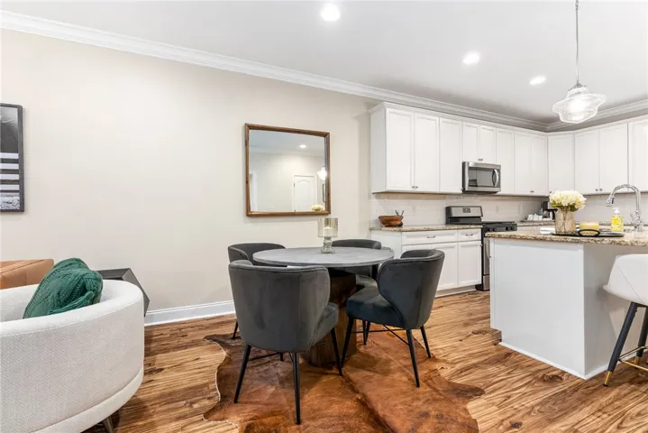 This open concept space features a dining area that seamlessly connects to a modern kitchen.