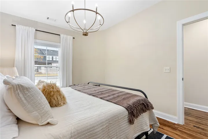 Bright and airy sleeping quarters feature rich hardwood flooring.