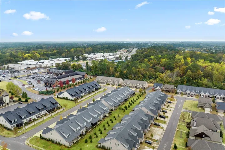 This elevated view captures a vibrant community nestled amidst lush, expansive greenery.