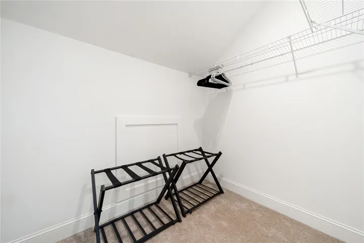 This ample closet space features convenient storage solutions for an organized wardrobe.