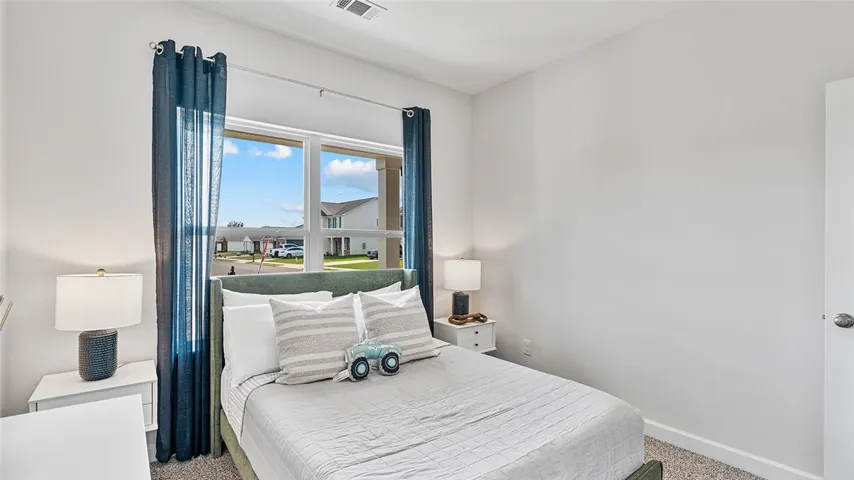 This bright bedroom provides ample natural light and a serene retreat.