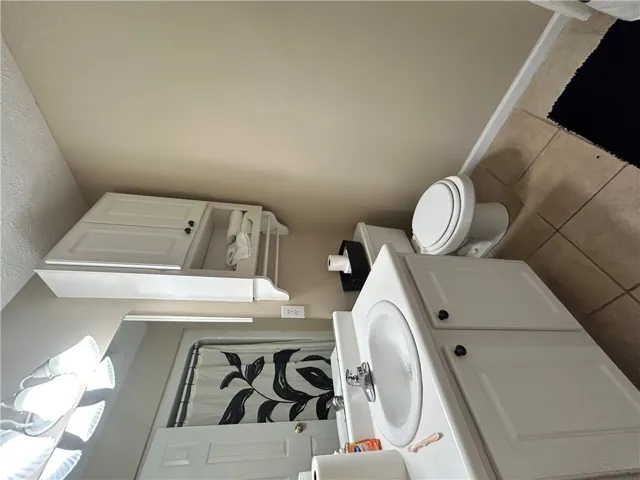 This functional bathroom features a clean design with essential amenities for daily routines.