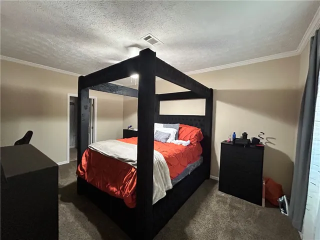 This spacious bedroom offers comfort and ample room for relaxation.