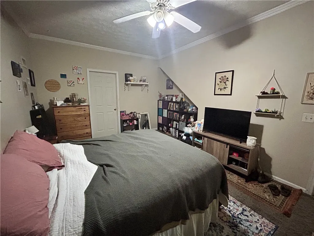 This cozy bedroom offers a tranquil retreat with soft lighting and ample space for relaxation.