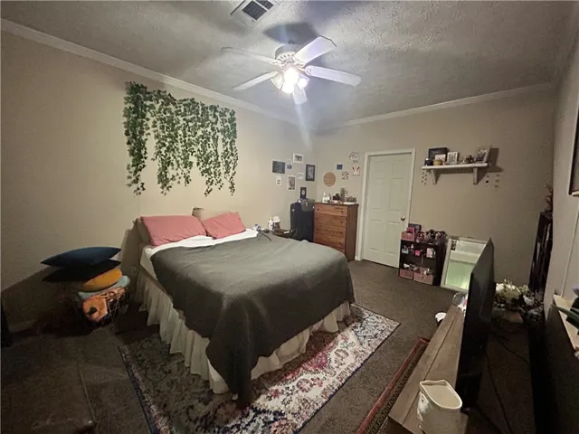 This cozy bedroom features comfortable flooring and ample natural light, ideal for relaxation.