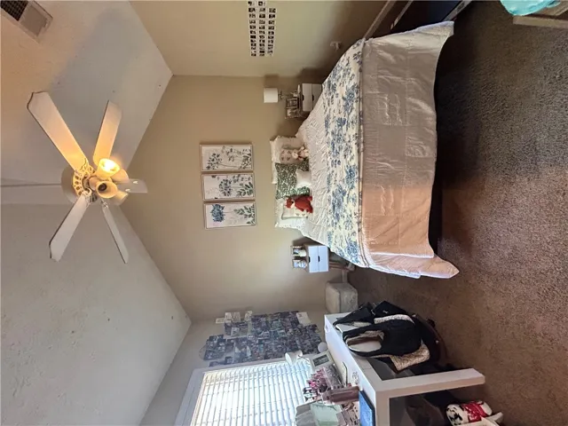 This cozy bedroom offers comfort and natural light for restful living.