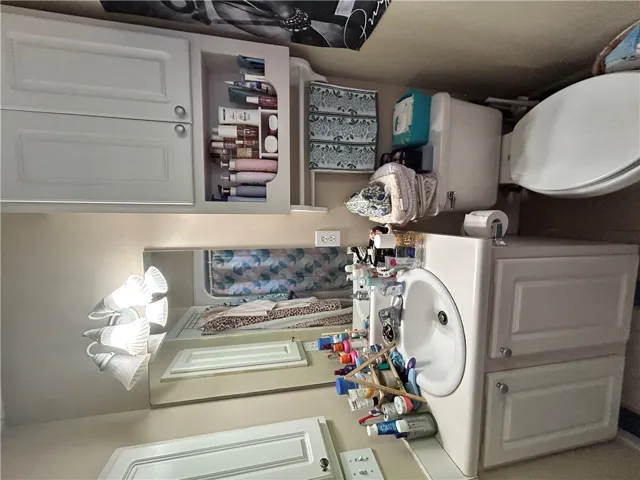 This bathroom features practical storage solutions and classic fixtures for everyday comfort.