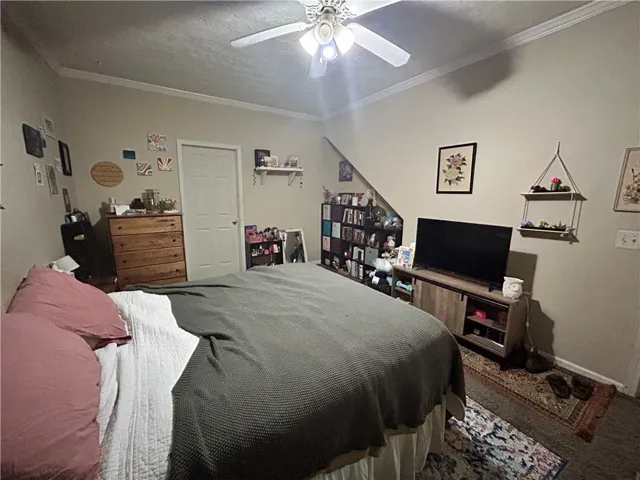 This cozy bedroom offers a tranquil retreat with soft lighting and ample space for relaxation.