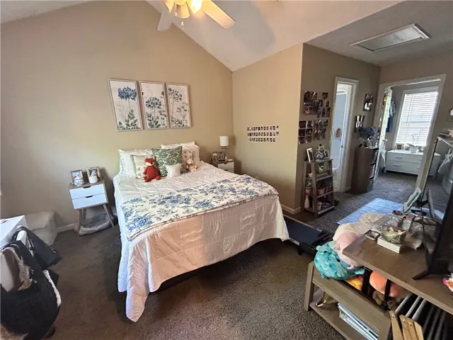 This inviting bedroom features vaulted ceilings, providing a spacious and airy retreat.