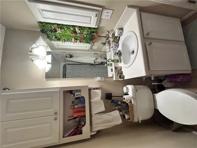 This clean bathroom features a classic vanity and well-maintained fixtures.