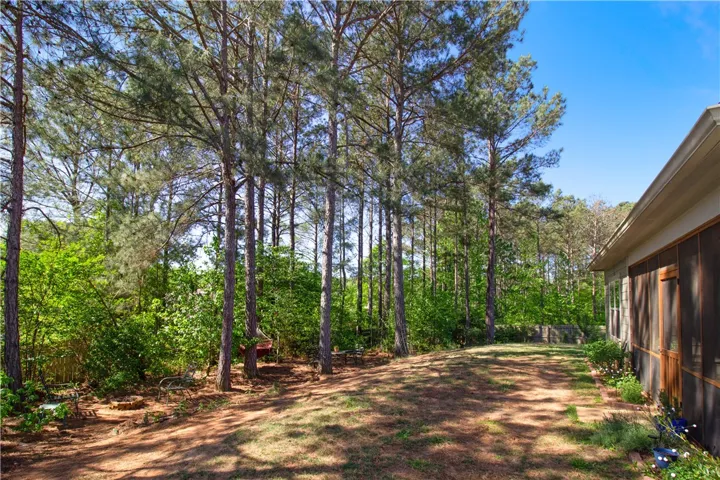 This spacious yard offers a tranquil retreat with mature trees and a private setting.
