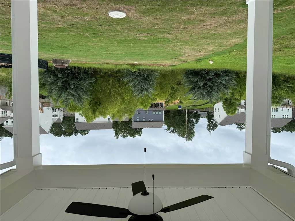 A deep backyard extends to mature trees and a tranquil greenbelt, offering neighborhood privacy.