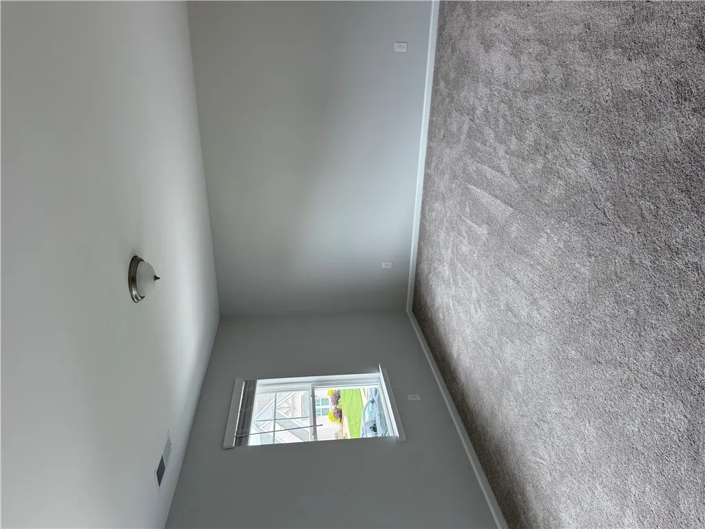 Plush carpeting defines this tranquil space, ready for personalized touches.