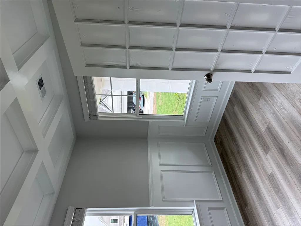 Elegant coffered ceilings elevate this room with distinctive architectural detail.
