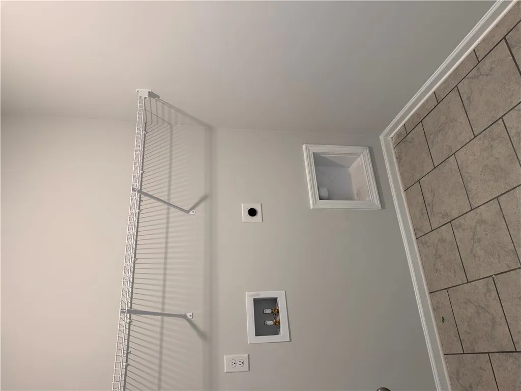 Functional utility space with convenient connections for laundry essentials.