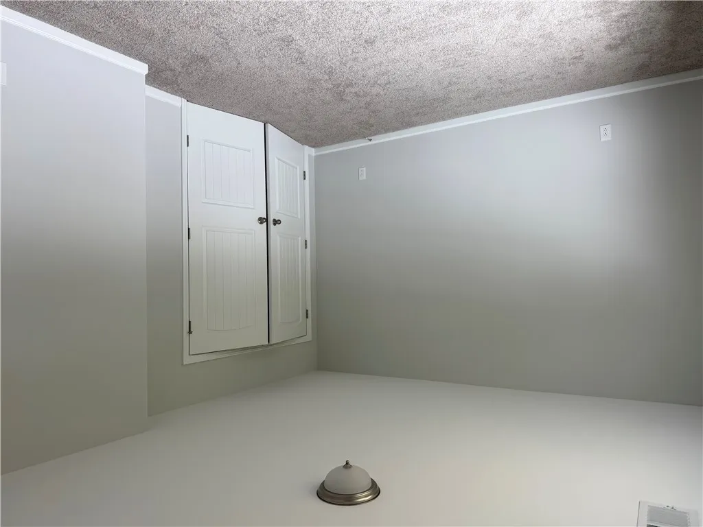A compact storage closet with classic paneled doors is neatly integrated into a room.