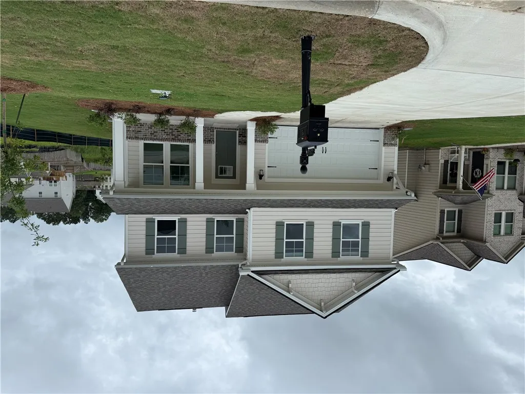 A classic two-story residence with a welcoming porch and attached garage.