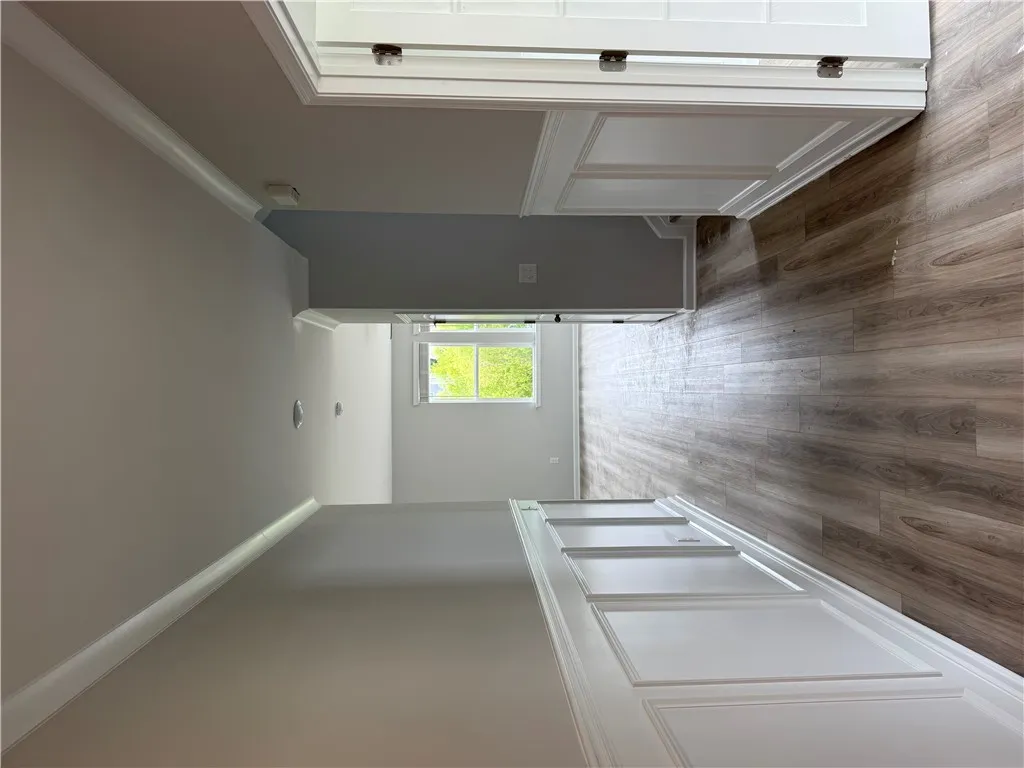 Hardwood-style flooring and natural light create an inviting, open-concept space.