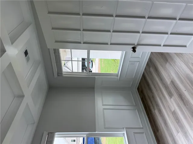 Elegant coffered ceilings elevate this room with distinctive architectural detail.