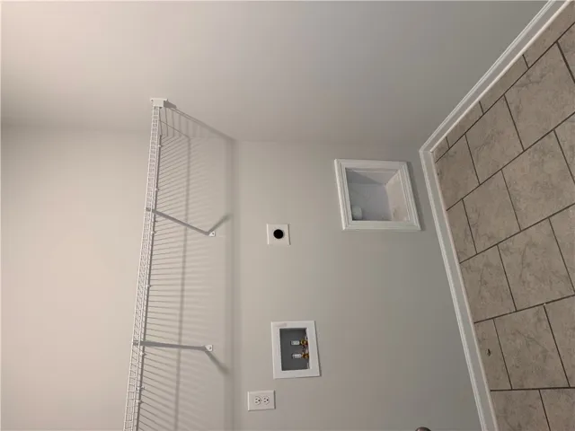 Functional utility space with convenient connections for laundry essentials.