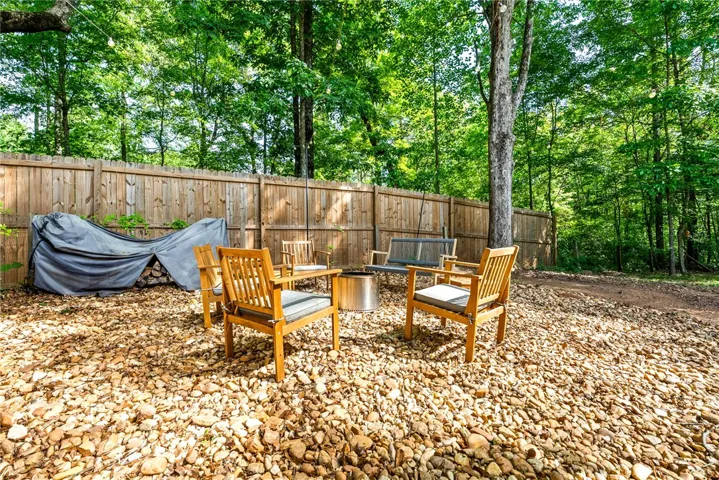 This tranquil outdoor space offers a private retreat surrounded by lush greenery.