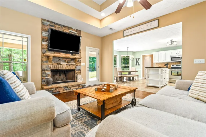 This inviting space features an open layout connecting living, dining, and kitchen areas.