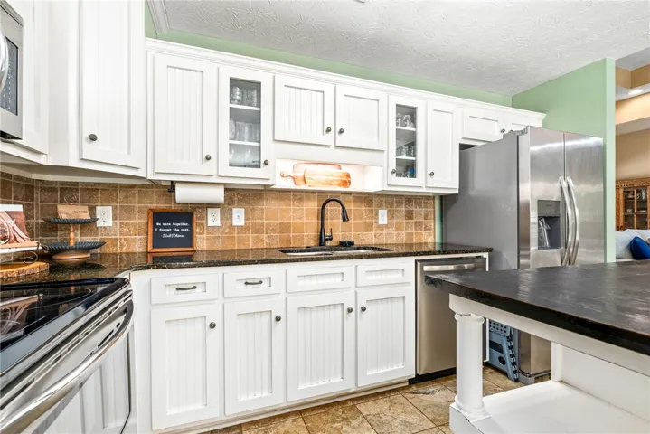 This bright kitchen features granite counters and stainless steel appliances.